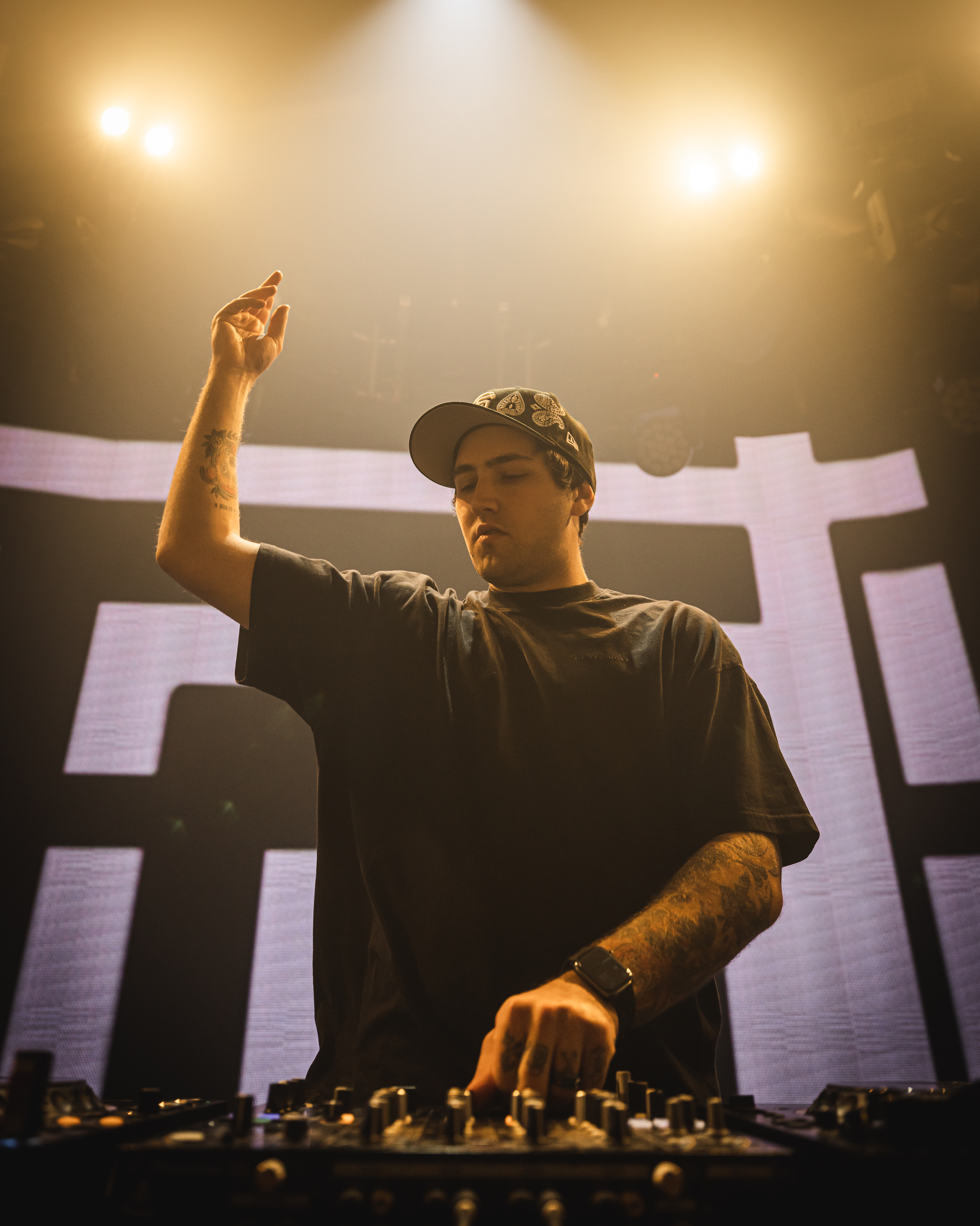 Jauz deejaying in a black shirt and fitted ball cap