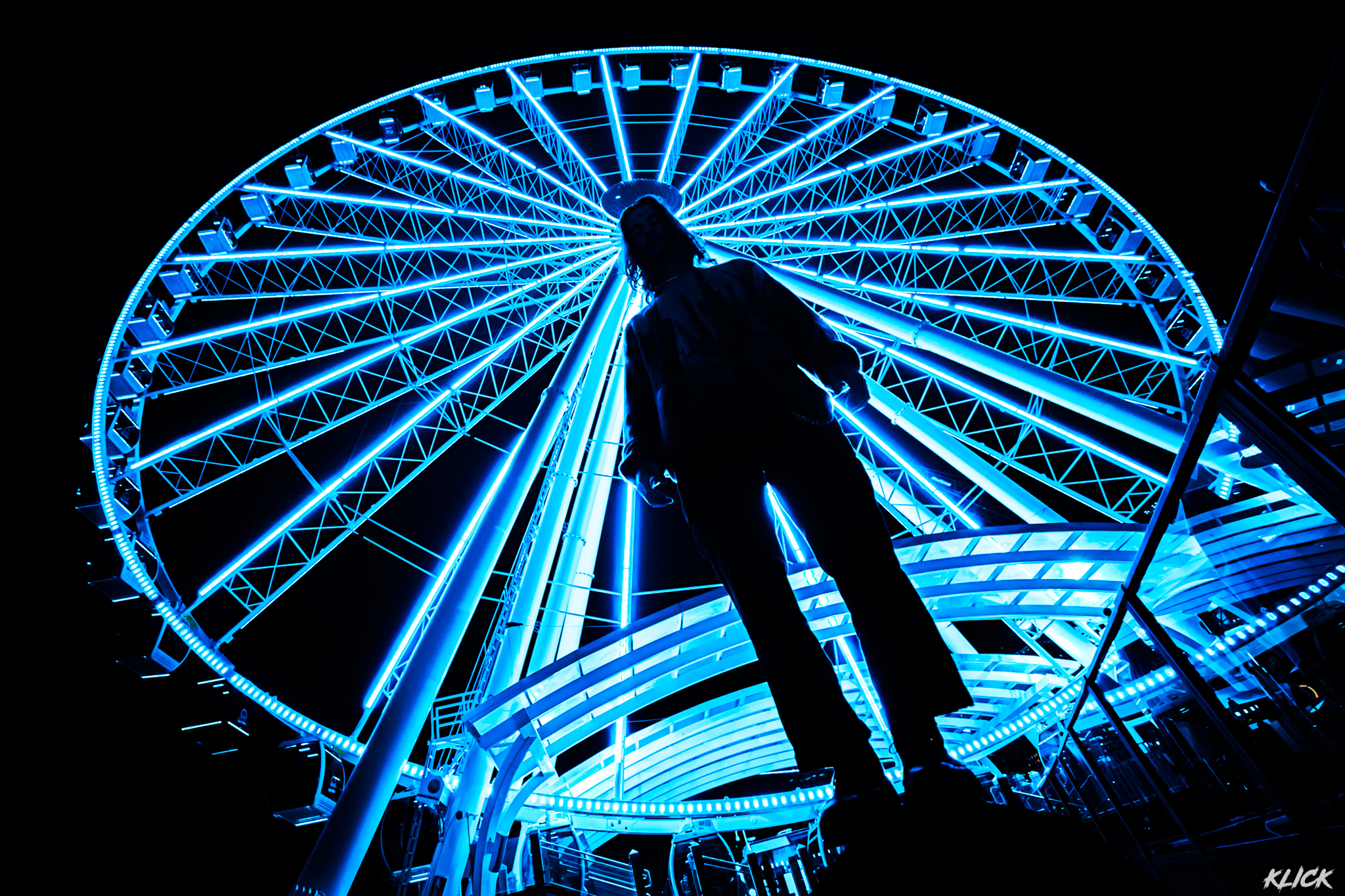 Meduso Press Shot: standing in front of blue farris wheel lit up