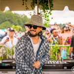 DJ wering bucket hat and checkered jacket at Imagine Music Festival 2023