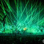 Green lights and lasers above a large crown at Music Festival 2023