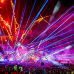 Purple and orange lights, lasers and fireworks going off at the mainstage at Music Festival 2023