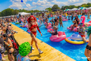 Girl in red two piece bathing suit walking by the pool at Imagine Music Festival 2023