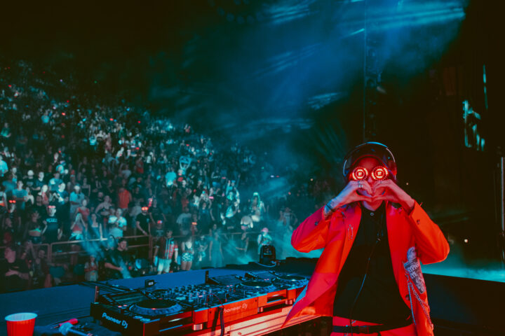 Photo of REZZ throwing up heart sign at Red Rocks