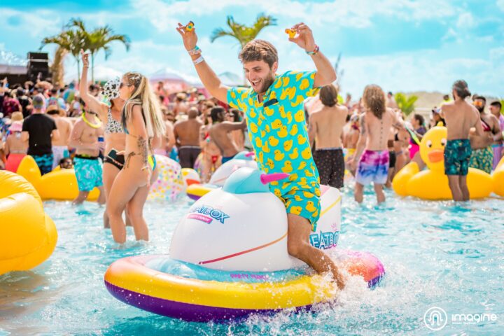 Imagine Music Festival pool party: man in duck shirt floating in pool