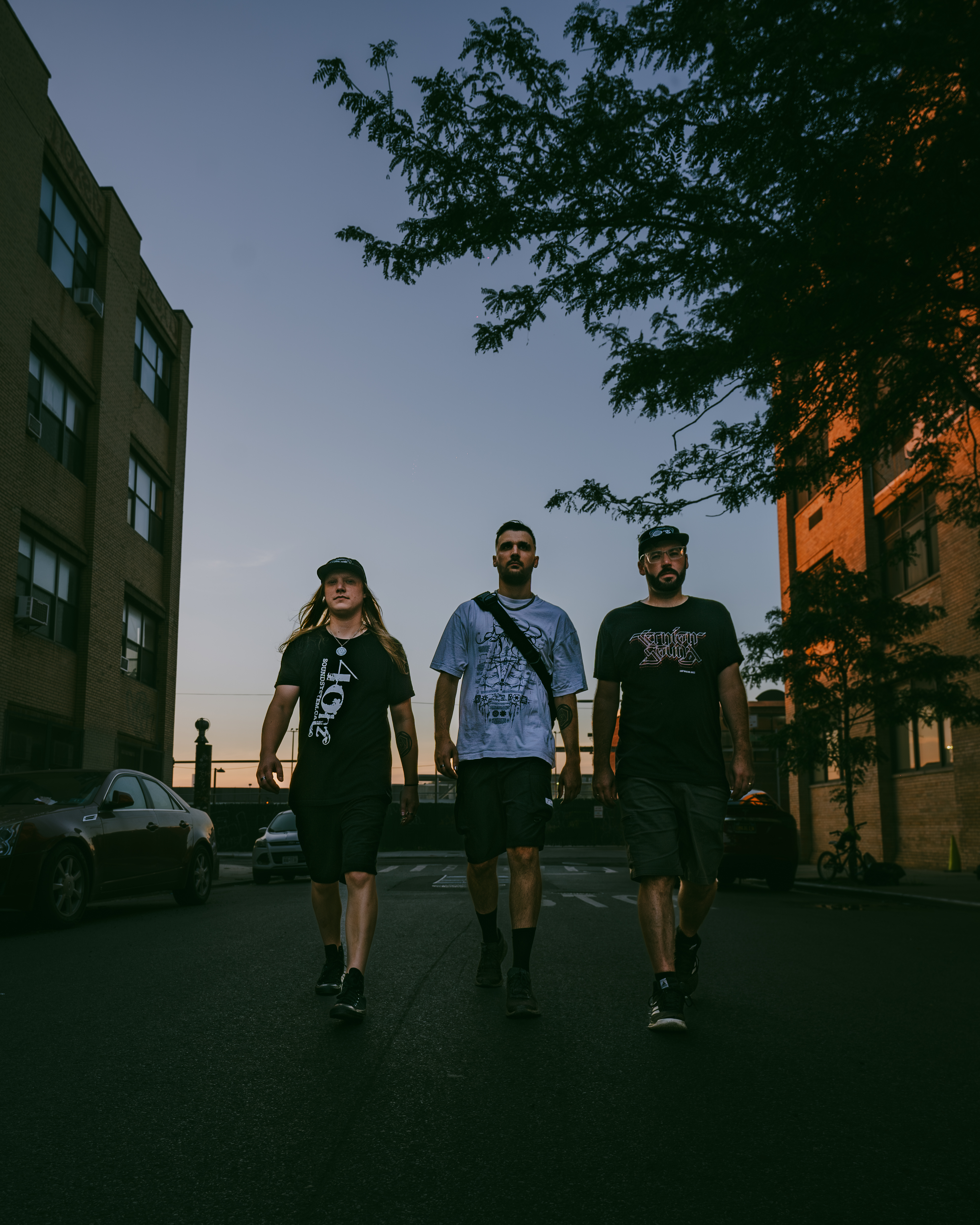 Ternion sound trio walking on the street during sunset