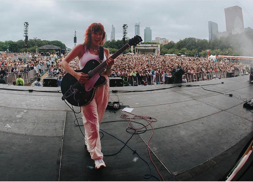 UPSAHL at Lollapalooza main stage 2023. Holding a guitar, back against the audience