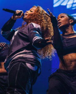 SZA performing the SOS Tour with dancers on stage with blue background in Tampa, FL